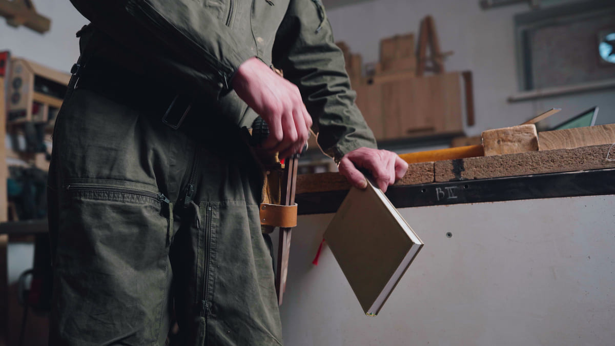 Craftsman at his workbench in a warmly lit workshop